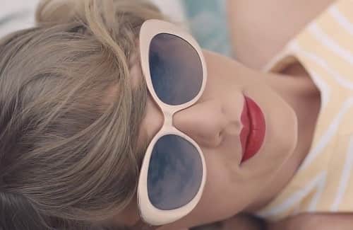 Taylor Swift relaxing in a pair of cat-eye sunglasses