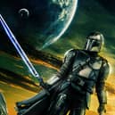 A promotional image for The Mandalorian S3, depicting Pedro Pascal as Din Djarin in front of a yellow and green sky (Credit: Disney+)