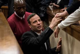 Olympic athlete Oscar Pistorius holds the hand of a relative after sentencing at the High Court on July 6, 2016 at the High Court in Pretoria, South Africa. Pistorius was sentenced to six years in prison for the murder of girlfriend Reeva Steenkamp at their home in 2013.