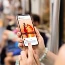 Woman on Metro scrolling through Instagram