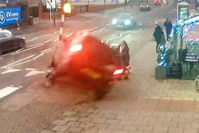 CCTV capturing the dramatic moment a mum managed to pull her two-year-old daughter to safety seconds before her pram was crushed underneath a car in a heart-stopping crash (SWNS)