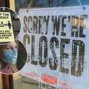 Remembering the first Covid lockdown four years on. A 'closed' sign from when all non-essential retailers were ordered to shut. Inset: Social distancing measures were in place to stop the spread of Covid-19 and below: A woman wears a mask to protect herself and others from spreading the virus. 