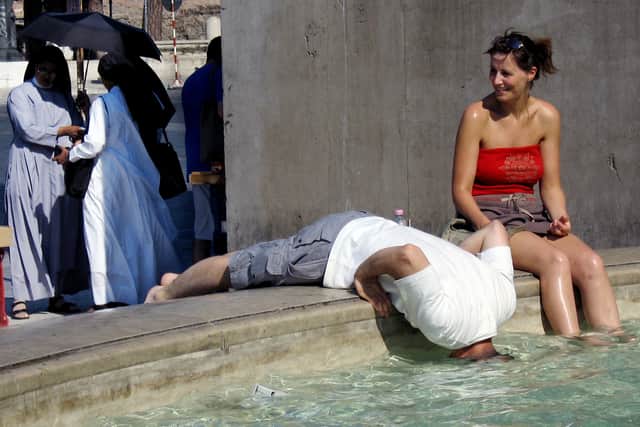 Tourists refresh themselves in the water of a fountain in downtown Rome in 2005 (Photo: VINCENZO PINTO/AFP via Getty Images)