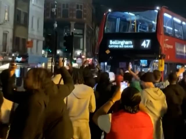 Excited England fans dance around “Bellingham” bus.