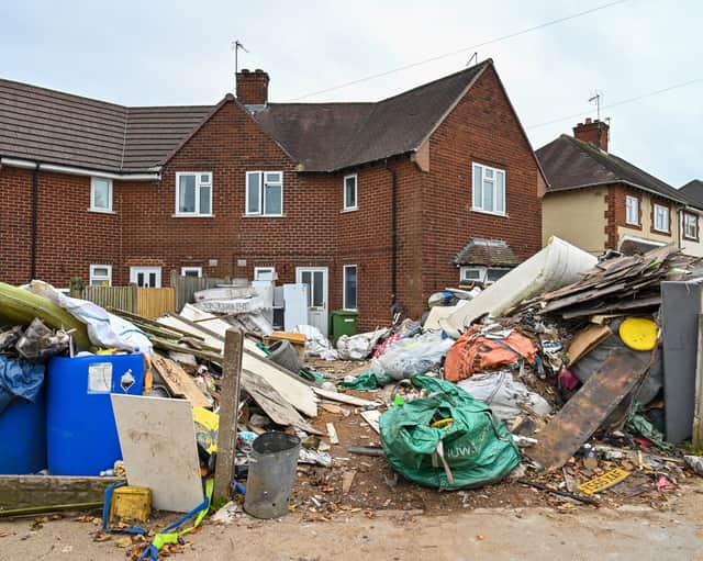 Horrified residents are demanding action after their neighbours turned their home into a makeshift TIP with tonnes of rubbish dumped on the driveway.