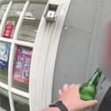 Man tries to take swig of his lager while being arrested for drink driving.