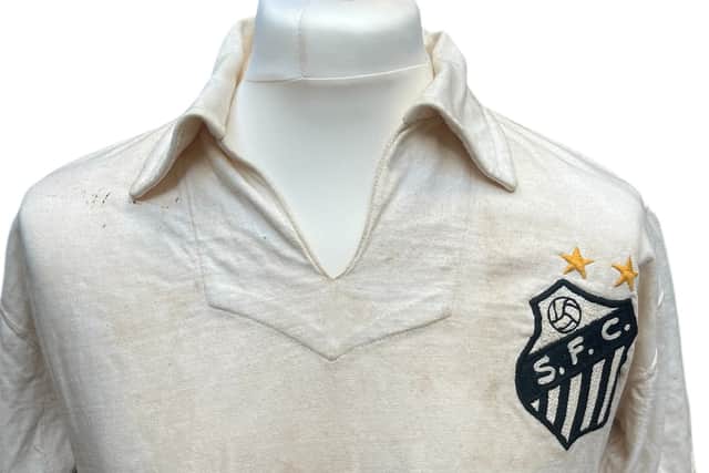 The football shirt worn by Pele when he scored his landmark 1,000th career goal is set to sell at auction for as much as £400,000.