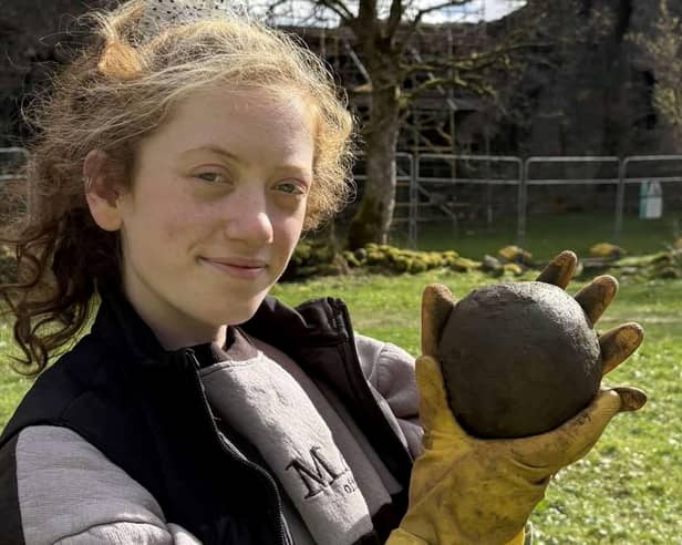 Magnet Fishing Edinburgh's Eryn and the 350-year-old cannonball found in the River Lochy in the Scottish Highlands. 