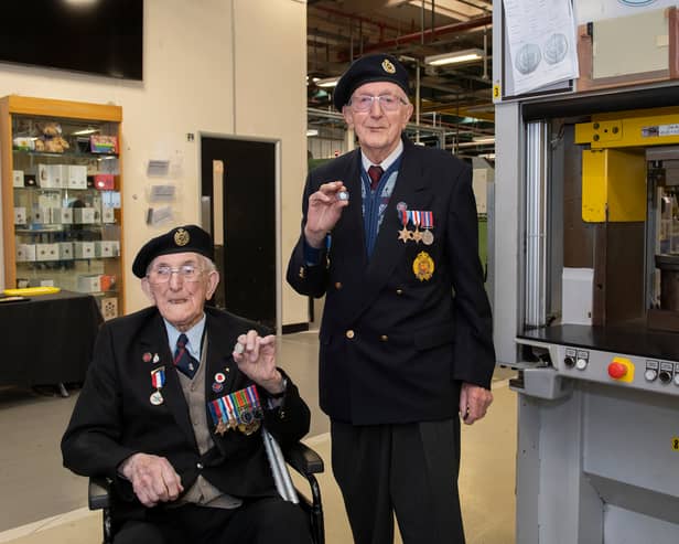 Veterans Richard Pelzer (left), 101, and Ron Horsey, 98, who both served with the Royal Engineers, holding the new VE Day 50p coin at the Royal Mint manufacturing site in South Wales (Photo: The Royal Mint)