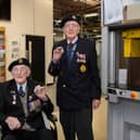 Veterans Richard Pelzer (left), 101, and Ron Horsey, 98, who both served with the Royal Engineers, holding the new VE Day 50p coin at the Royal Mint manufacturing site in South Wales (Photo: The Royal Mint)