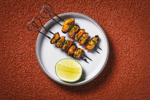Mussels’ skewers with roasted chicken wing butter sauce. Credit: Oh Gravy! Media - Burak Can Aksit