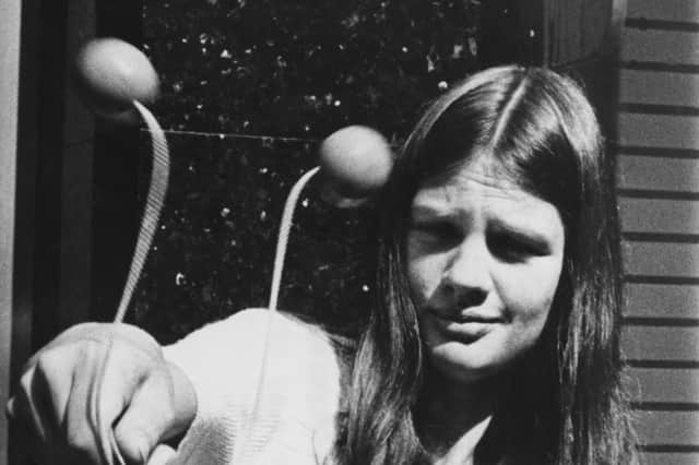 A child playing with clackers