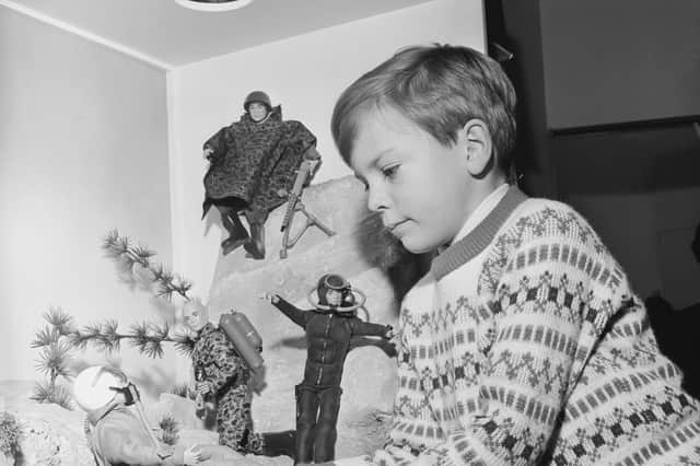 A young boy playing with Action Man toys in 1966