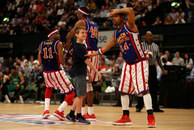 A basketball fan shares a magical moment on court with the Harlem Globetrotters.