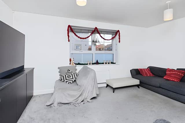 The bright dual-aspect lounge benefits from views towards the green, giving the main reception room an open outlook