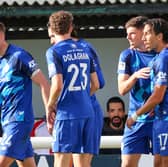Ellis Taylor, second from right, is congratulated by his Harrogate Town team-mates after finding the net at Woking FC. Picture: Matt Kirkham