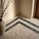 ROMAN LUXURY Lapicida’s Calacatta Gold Marble Mosaic creates an elegant statement floor with contrasting Verde Guatemala detailing.