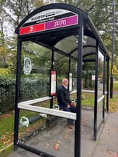 A passenger waits at the broken bus shelter at Wetherby Road in Harrogate.