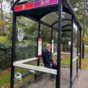 A passenger waits at the broken bus shelter at Wetherby Road in Harrogate.
