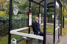 A passenger waits at the broken bus shelter at Wetherby Road in Harrogate.