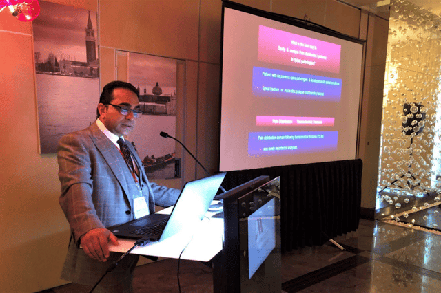 Consultant spinal surgeon Mr Raman Kalyan delivering an expert presentation on spinal conditions and treatment options.