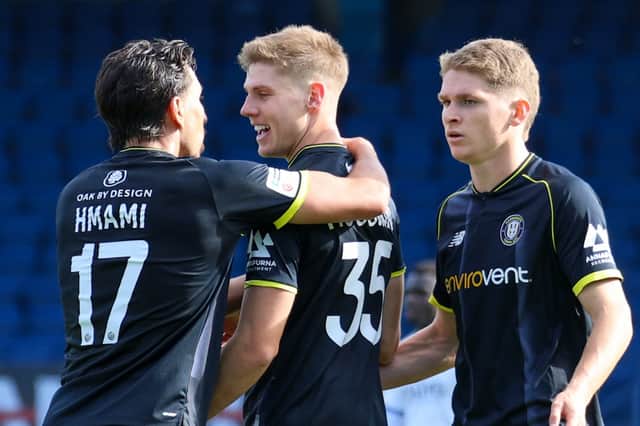 Ciaran McGuckin, centre, is congratulated by Josh Hmami, left, and Michael Craig after finding the back of the net against Bury FC. Picture: Matt Kirkham
