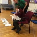 Starbeck St John Badger Stella demonstrating how to help a choking baby.