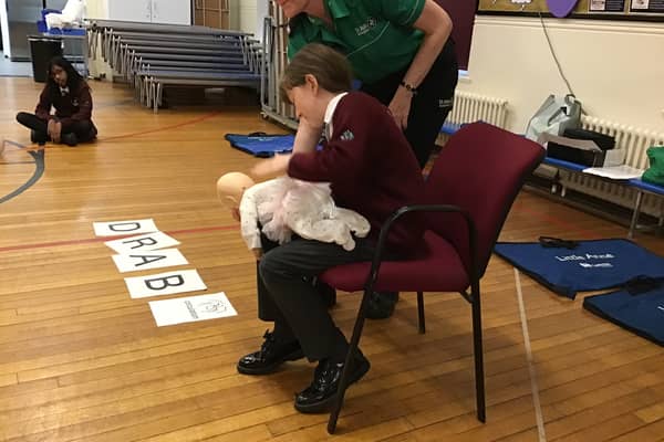 Starbeck St John Badger Stella demonstrating how to help a choking baby.