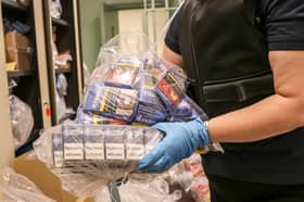 A member of North Yorkshire Council’s trading standards team with confiscated cigarettes and tobacco.