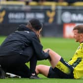 Will McGowan receives treatment from Harrogate Town physio Rachel McGeachie during Saturday's National League win over Sutton United. Picture: Matt Kirkham 