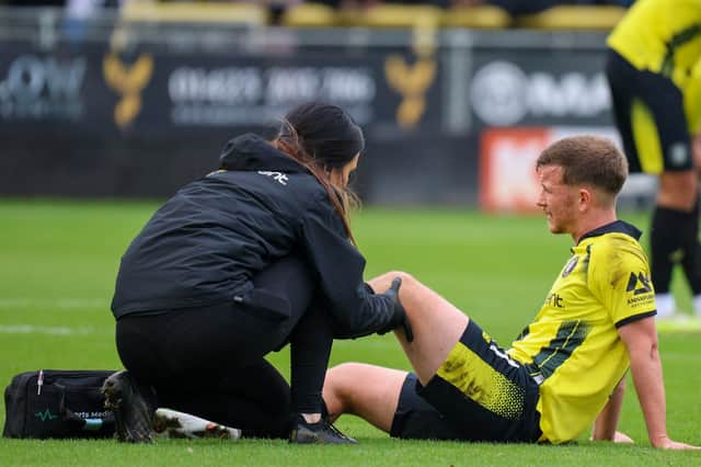 Will McGowan receives treatment from Harrogate Town physio Rachel McGeachie during Saturday's National League win over Sutton United. Picture: Matt Kirkham