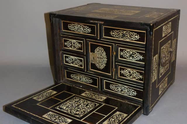 An early ebony and ivory inlaid table cabinet.