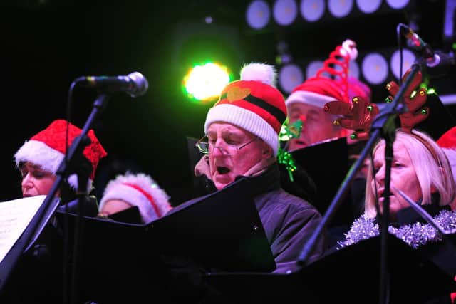 Getting the crowds into the Christmas spirit: Harrogate choir Reincantation. Picture: Gerard Binks.