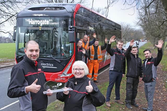 Driver Andrei Szabo-Ludovic (left) and Training Manager Colleen Wormald celebrate with colleagues from The Harrogate Bus Company.