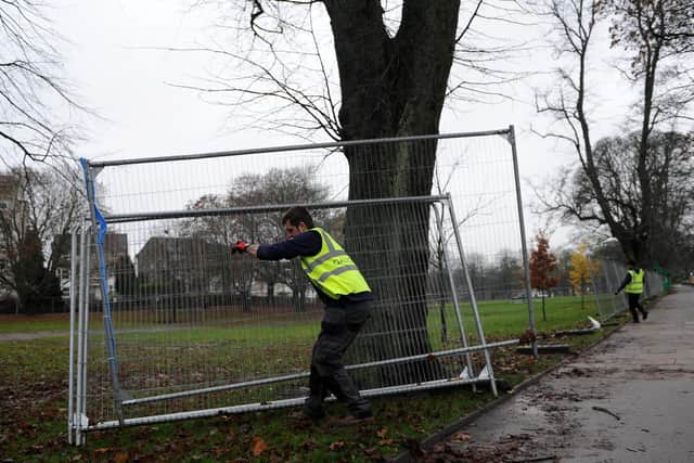 Workmen hard at work taking down some of the fencing on the devastated Stray at West Park in Harrogate.