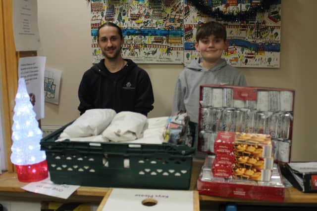 Harry hands over donations to the Harrogate Homeless Project.