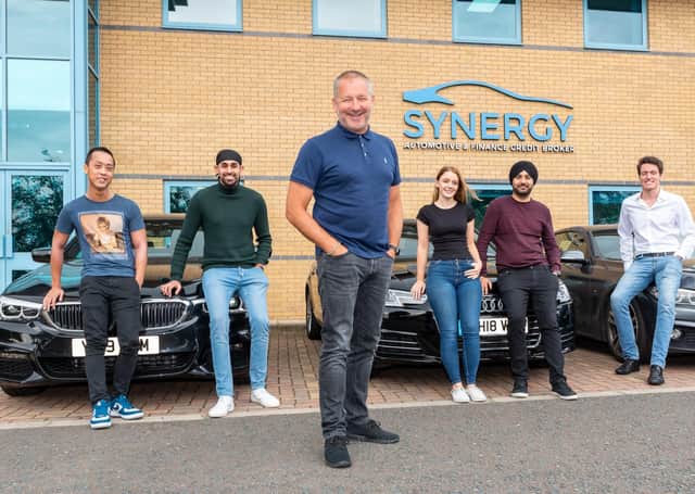 Synergy CEO Paul Parkinson, pictured with some of the vehicle finance company’s employees. (S)