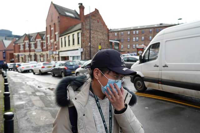 A student wearing a face mask walks close to the Royal Victoria Infirmary where two patients who have tested positive for the Wuhan coronavirus are being treated by specialist medical workers in Newcastle upon Tyne. Picture: Ian Forsyth/Getty Images