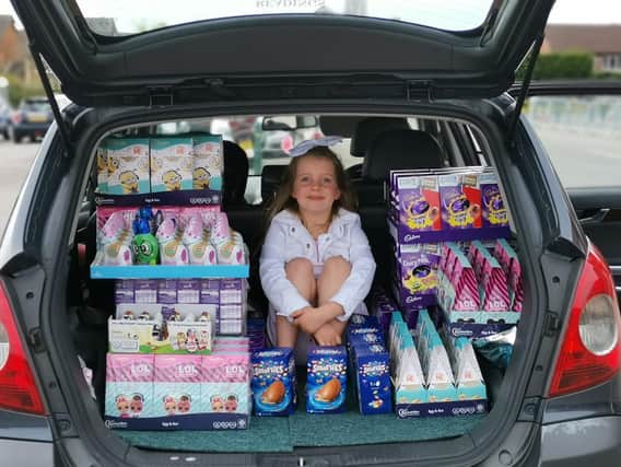 Harrogate girl Darcie Wason, six, who goes to Hookstone Chase Primary School, in the boot of her mum and dad's car with just some of the Easter eggs she is donating.