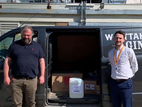 Toby Whittaker of Whittaker's Gin delivers the hand sanitiser to Dan Thirkell, charity fundraising manager at the Harrogate & District NHS Foundation Trust.