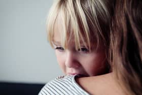 sad crying little girl hugging mother, parenting concept