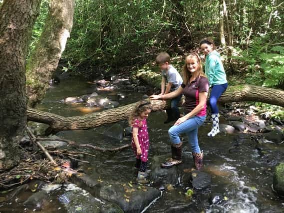 Supporting Long Lands Common project - Harrogate's Marianne Williams with her and her late husband Pauls children Ellie and twins Wilfie and Rosie in his favourite spot - Nidd Gorge.
