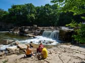People enjoying the warm weather beside the River Swale at Richmond Falls. Picture Bruce Rollinson