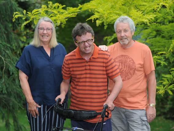 Feelings are running high over Henshaws plans for its facilities in Harrogate and Knaresborough. Pictured is one of the art makers, Joe Thackwray with his parents Becky and Brian. (Picture Gerard Binks)