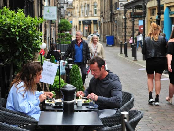 A couple are pictured enjoying a bit to eat outside LMDC Expresso Bar on John Street in Harrogate on Saturday as the hospitality sector started to reopen after lockdown. (Picture Gerard Binks)
