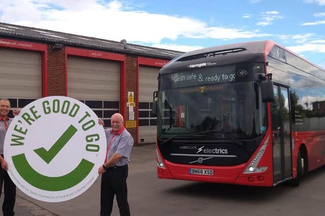 Chris Long (left) and Frank Paul from The Harrogate Bus Company celebrate the award of a tourism tick confidence mark to the bus firm by tourism agency VisitEngland.
