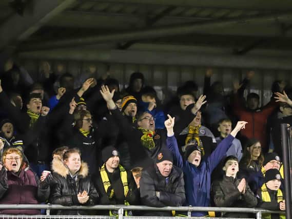 Harrogate Town supporters cheer on their team at the CNG Stadium. Picture: Matt Kirkham