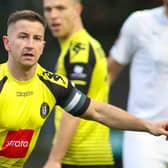 Harrogate Town skipper Josh Falkingham points the way. Pictures: Matt Kirkham