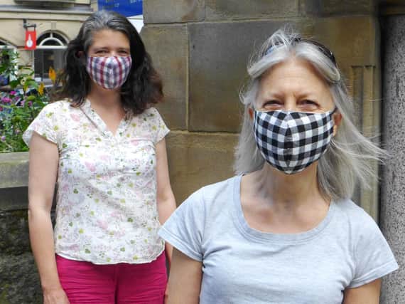 Call to check what face mask you are buying - Harrogate Fair Trade Shop's Victoria Wild and volunteer Gillian Parkin wearing the reusable HFTS masks.