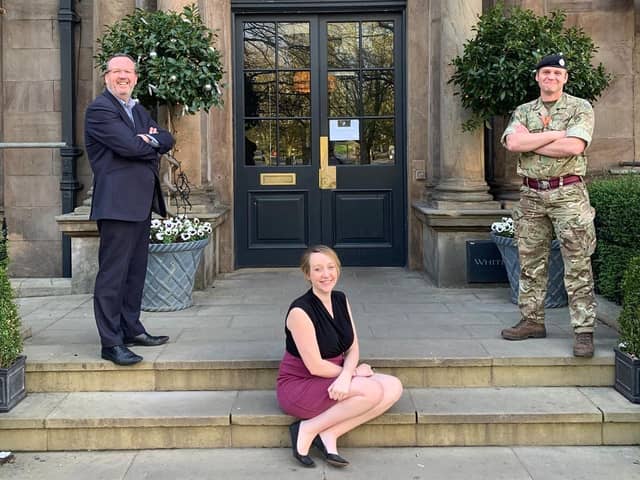 The White Hart Hotel team, Fran Patrick and Simon Cotton with a member of the MOD.